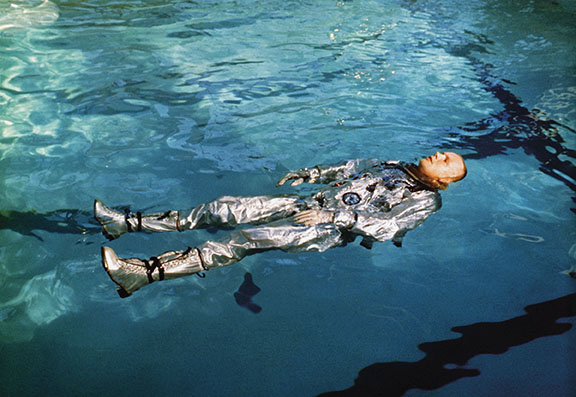 Armstrong appears relaxed while wearing a space suit and floating in a tank in October 1963 during water survival training at the Naval Aircrew Candidate School in Pensacola, Florida. (NASA)