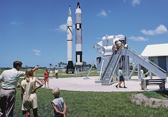 Tourists take in the rocket and spacecraft display at KSC Visitor Center. “Apollo fever” was gripping the country as KSC became the focal point for the upcoming Moon launch. More than 8,000 people were touring the Moonport daily in the week leading up to the launch. (Photo by Tiziou News Service)
